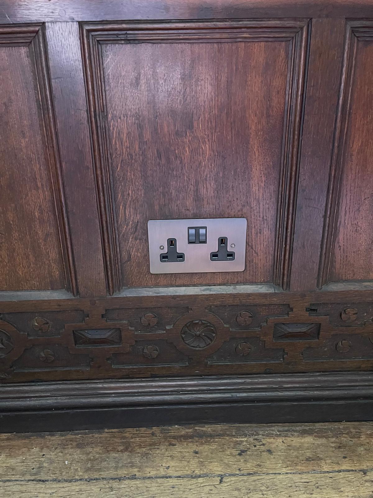 Dark socket fronts installed into timber panelling