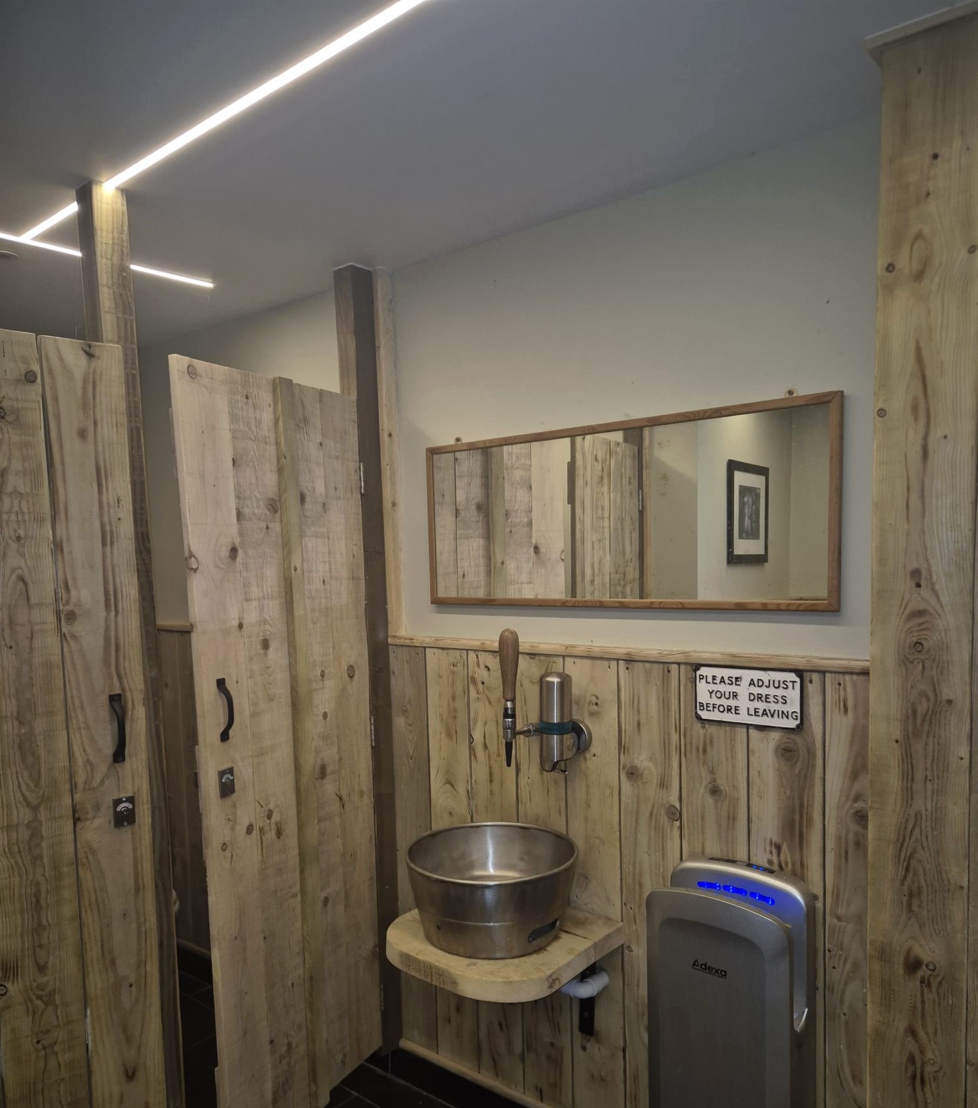 Linear LED lighting in a unique pub washroom